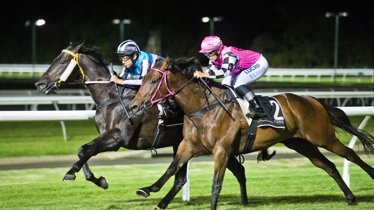 Tisani Magic and jockey Emma Ljung (outside) on their way to victory at Clifford Park last season. Pictures: Nev Madsen