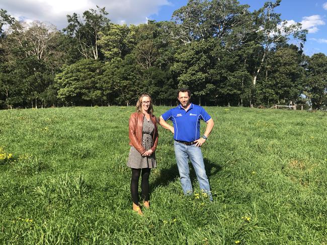 North Coast Community College executive officer Kate Kempshall with NSW Department of Primary Industries' North Coast manager, Bill Quince, in the indigenous bush food paddock with the Big Scrub remnant behind.