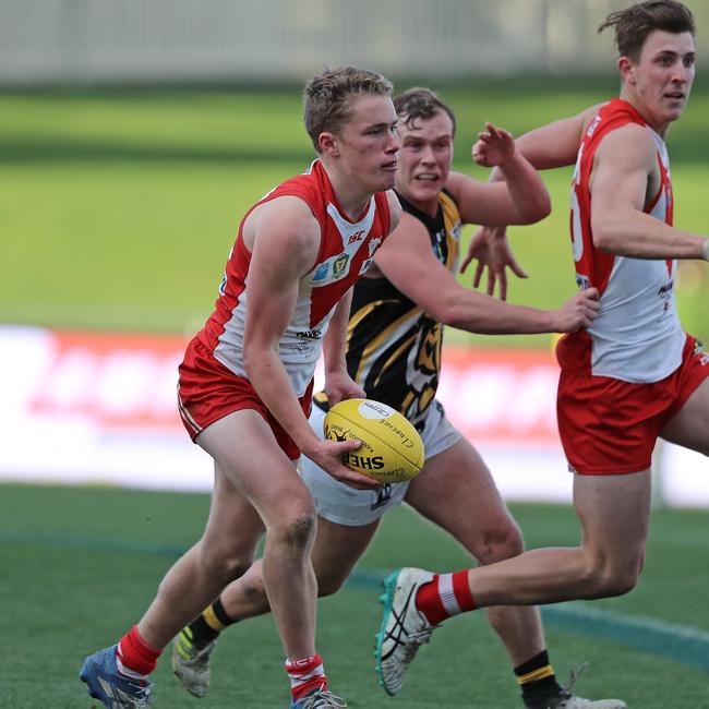 TSL: Clarence's Jack Preshaw looks to feed the ball off by hand against the Tigers. Picture: LUKE BOWDEN