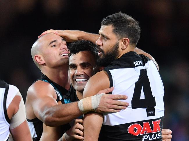 (L-R) Sam Powell-Pepper, Lindsay Thomas and Patrick Ryder of the Power celebrate a goal during the Round 13 AFL match between the Port Adelaide Power and the Western Bulldogs at Adelaide Oval in Adelaide, Thursday, June 14, 2018. (AAP Image/David Mariuz) NO ARCHIVING, EDITORIAL USE ONLY