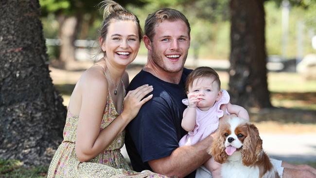 Tom Burgess and Tahlia Giumelli with their 6 month old daughter Sophie and dog Ted. Picture: Tim Hunter.