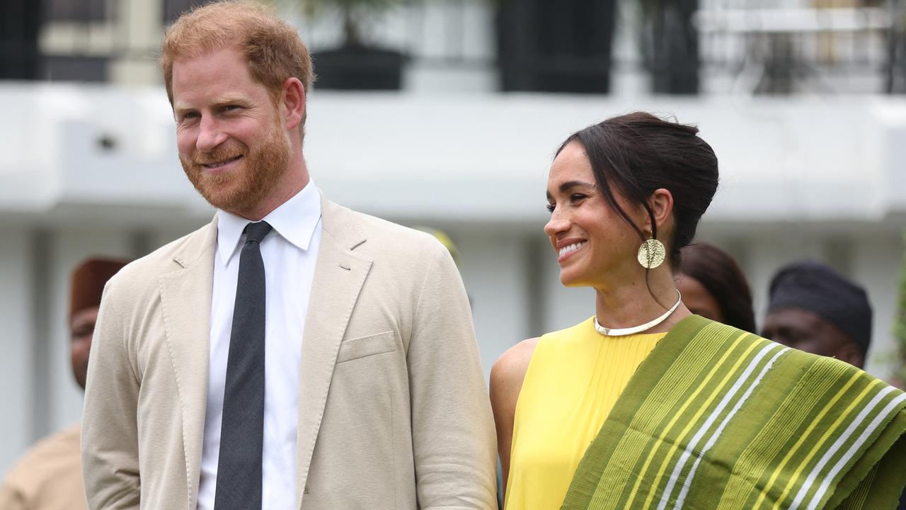 Britain's Prince Harry (2ndR), Duke of Sussex, and  Britain's Meghan (R), Duchess of Sussex, react as Lagos State Governor, Babajide Sanwo-Olu (unseen), gives a speech at the State Governor House in Lagos on May 12, 2024 as they visit Nigeria as part of celebrations of Invictus Games anniversary. (Photo by Kola SULAIMON / AFP)