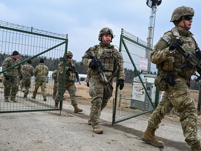 *** BESTPIX *** WOLA KORZENIECKA, POLAND - MARCH 07: U.S. Army soldiers assigned to the 82nd Airborne carry military equipment as they take part in a exercise outside the operating base at the Arlamow Airport on , 2022 in Wola Korzeniecka, Poland.  The U.S., in response to the Russian military buildup and subsequent invasion of Ukraine and in concert with other NATO member states deploying additional troops across eastern European countries, has sent thousands of troops to Poland, where they have set up bases at Rzeszow and at two small airfields, both not far from Poland's border to Ukraine. Meanwhile fighting between the Russian military and Ukrainian armed forces is raging across Ukraine. (Photo by Omar Marques/Getty Images)