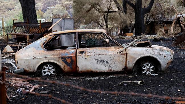 A burnt car on a property on Mount Bold Rd after the Cherry Gardens bushfire. Picture: Kelly Barnes