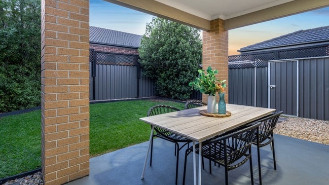 The home’s sliding doors roll back to reveal an under-the-roofline outdoor entertaining area.