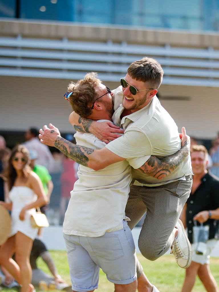 Jack Maybank (L) and Luke Powell jumping for joy as punters enjoy 2020 Great Northern Darwin Cup. Picture: GLENN CAMPBELL