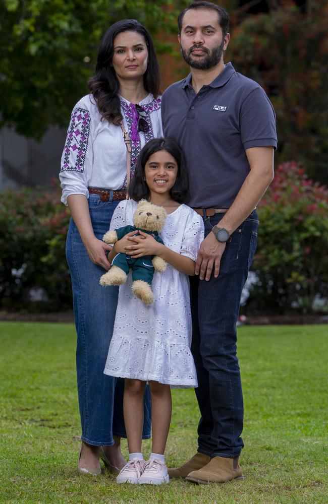 Leenah Ali, 7, with her parents Aysha Daud and Ali Azhar. Picture: Jerad Williams