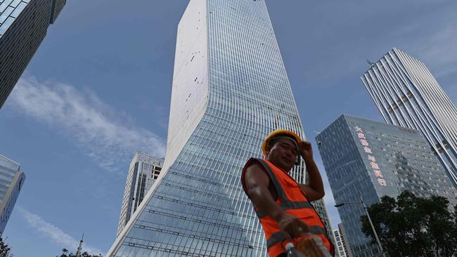 A worker in front of the Evergrande headquarters in Shenzhen, southeastern China. Picture: Noel Celis/AFP