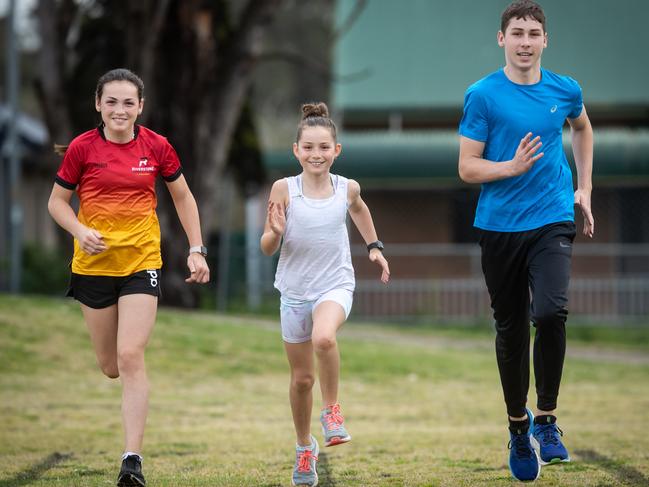 Keen runners Marlee (13), Keira (9) and Nate Gill (15) having fun training at Riverstone Little Athletics. Picture: Julian Andrews.