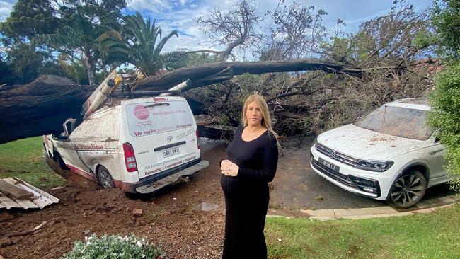 Kristen Stevens with cars that were struck by a fallen tree on Mitchell Street in Glengowrie. Picture: Michael Marschall