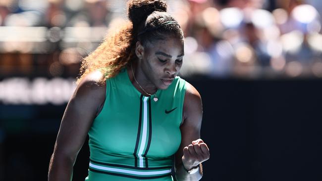 Serena Williams pumps herself up after winning a point on Rod Laver Arena. 