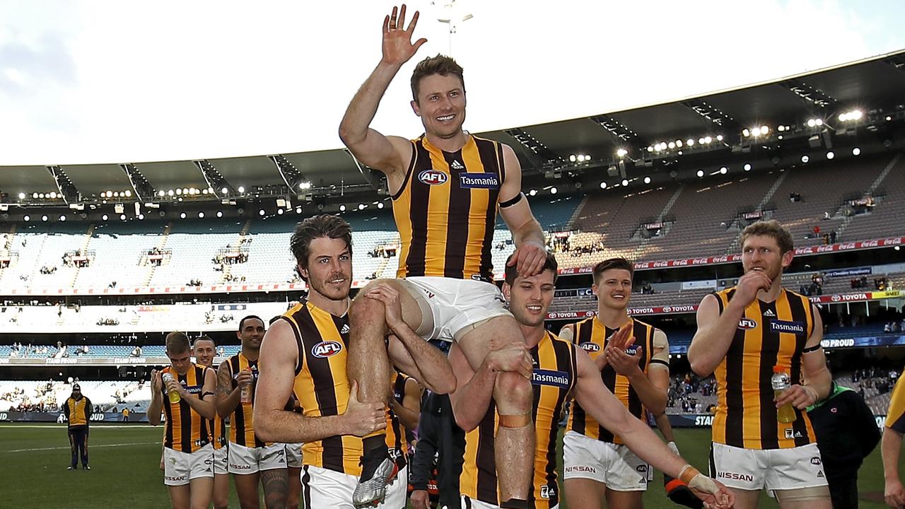 Isaac Smith and Luke Breust carry Liam Shiels from the ground after his 200th game. Picture: Getty Images