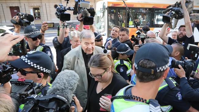 Police had to form a barricade to separate Pell from the media, protesters and supporters. Picture: Alex Coppel.