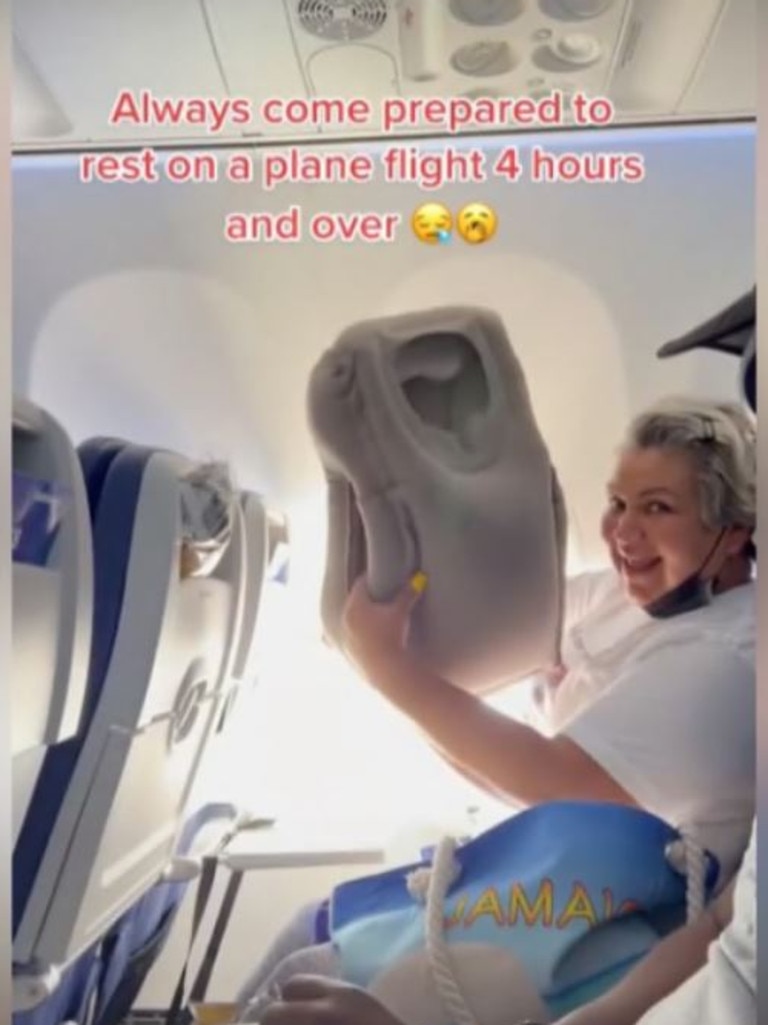 In the video, Wendy had taken her shoes and socks off and was resting her feet in a sling that was wrapped around the tray table to keep it in place.