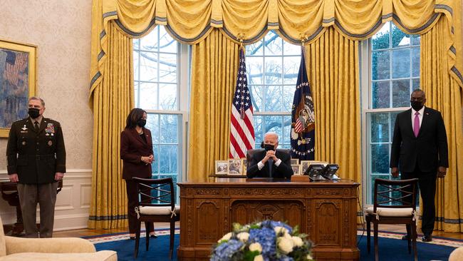 US President Joe Biden and Vice-President Kamala Harris peak with Secretary of Defence Lloyd Austin, right, and the chairman of the Joint Chiefs of Staff, Mark Milley in the Oval Office early this year. Picture: AFP