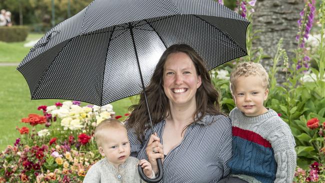 Brooke Reeson with her sons, Leo (9 months) and Judah (2yo) brave the showers during a morning at Queens Park Monday, October 17, 2022. Picture: Nev Madsen.