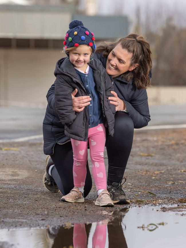 Alex Branden and her daughter Charlotte of Jamestown excited to see puddles of water finally. Picture: Ben Clark