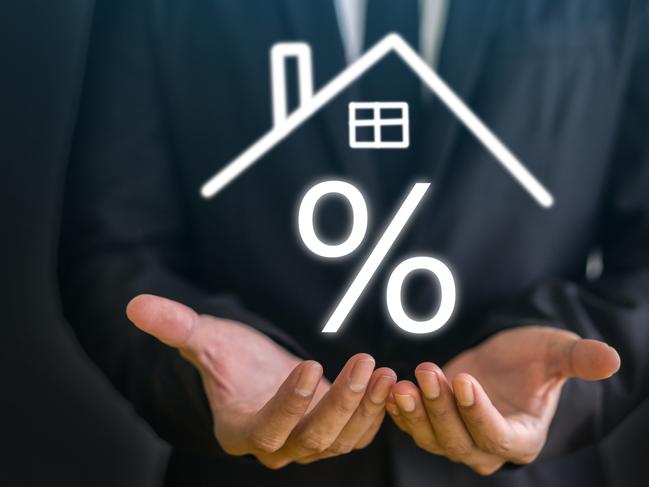 Businessman hold house with percentage, concept of real estate market trends, mortgage rates, property investment and housing market analysis, interest rates and financial planning, home ownership; home loan interest rate mortgage generic