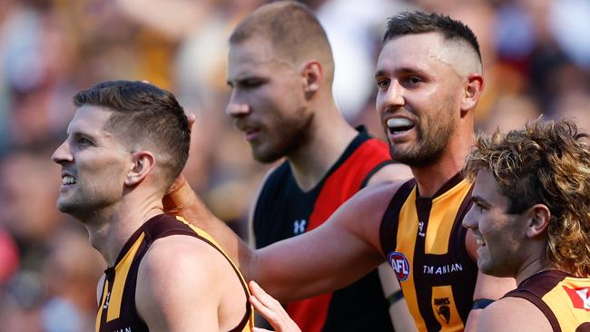 MELBOURNE, AUSTRALIA - MARCH 16: Jack Gunston of the Hawks celebrates a goal with teammate Luke Breust during the 2024 AFL Round 01 match between the Essendon Bombers and the Hawthorn Hawks at the Melbourne Cricket Ground on March 16, 2024 in Melbourne, Australia. (Photo by Dylan Burns/AFL Photos via Getty Images)