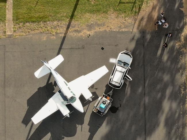 DAILY TELEGRAPH EXCLUSIVE  , FIVE Sydney men allegedly flew a flight plane by stealth from an outback desert airstrip to Papua New Guinea to pick up a massive haul of meth before being arrested when they landed back home late last night. In a feat of daring, AFP officers said the men loaded up a truck carrying hundreds of litres of aviation fuel in NSW before driving to the remote airstrip at Monto near Bundaberg where the plane was waiting for them on Monday night. They then left in the light plane under the cover of darkness at midnight and flew to PNG to pick up the massive drug haul. The flight evaded any radar detection. But the men were caught red handed peeling off fake rego stickers and fake PNG airlines stickers back in the QLD airstrip by AFP officers before being arrested, Picture: AFP