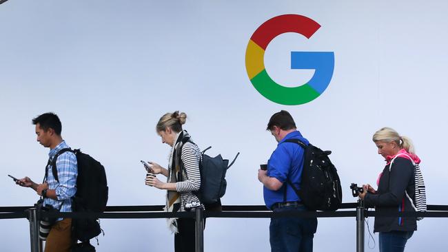 (FILES) In this file photo taken on October 4, 2017, attendees wait in line to enter a Google product launch event at the SFJAZZ Center in San Francisco, California. - Google parent Alphabet on February 2, 2021, reported that its quarterly profit rocketed some 50 percent to $15.2 billion at the end of last year as its digital ad business thrived. (Photo by Elijah Nouvelage / AFP)