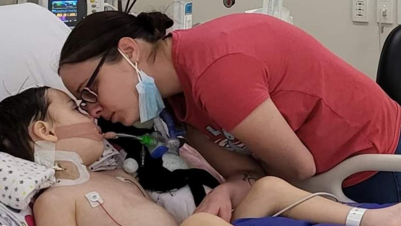 Mason Wade and mother Tara share a tender moment in the Brisbane Children's Hospital.