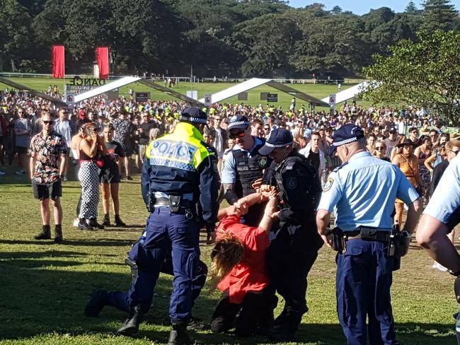 A man gets handcuffed by police at the Listen Out music festival in Centennial Park. Picture: Damian Shaw