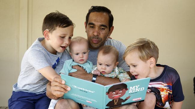 Adelaide’s Eddie Betts read to children Lewis 5, twins Alice and Maggie 7 months and Billy 3. Picture: Matt Turner