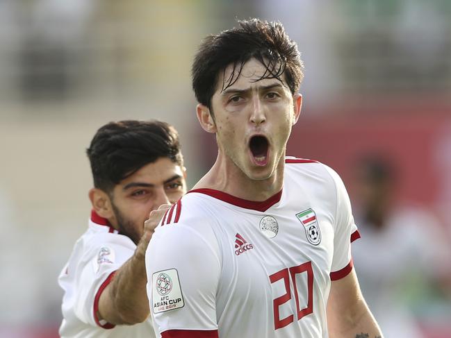 Iran's forward Sardar Azmoun, right, celebrates after scoring his side's second goal during the AFC Asian Cup group D soccer match between Iran and Vietnam at Al Nahyan Stadium in Abu Dhabi, United Arab Emirates, Saturday, Jan. 12, 2019. (AP Photo/Kamran Jebreili)