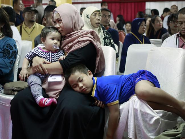 Relatives wait for the identification process of the victims at the main police hospital in Jakarta, Indonesia. Picture: AP