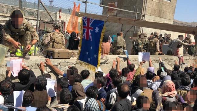 Afghans wait for hours in the crowded ditch, clinging to the papers they hope will gain them safe passage out of Afghanistan.