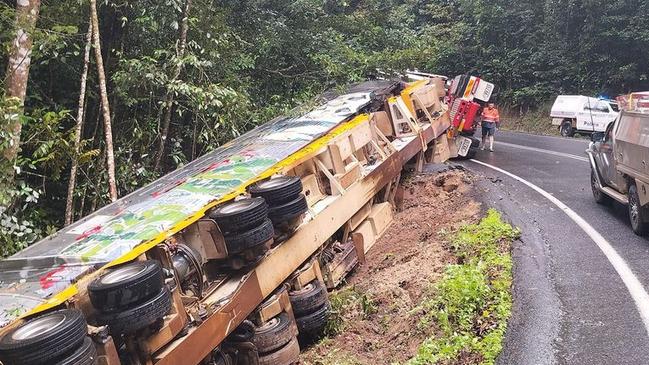 A crane will have to be trucked in from Townsville to right a prime mover transporting a rail motor which rolled on a windy Far North highway on Monday morning. Picture: Supplied