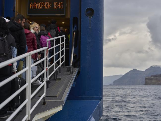 Passengers board a ferry bound for the Greek mainland, in the earthquake-struck island of Santorini. Picture: AP