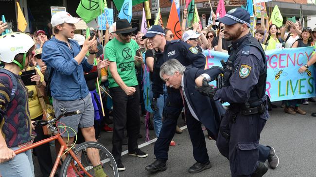 Mr Wolterding is dragged away as other protesters look on. Picture: AAP/Jeremy Piper