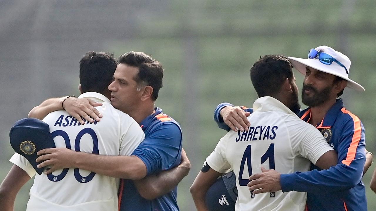 Rahul Dravid (2L) congratulates Ravichandran Ashwin (L) as batting coach Vikram Rathour (R) hugs Shreyas Iyer. (Photo by Munir uz ZAMAN / AFP)