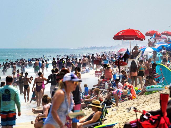 Thousands of beachgoers find refuge under umbrellas and in the water at Rehoboth Beach, Delaware, on July 28. Picture: Jim Watson/AFP