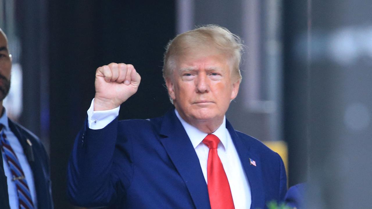 Former US President Donald Trump raises his fist while walking to a vehicle outside of Trump Tower in New York City. Picture: AFP