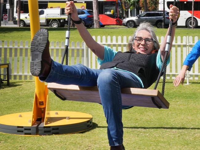 Lord Mayor Jane Lomax-Smith riding the latest installation in Victoria Square. The City of Adelaide has installed a giant bright yellow swing in Victoria Square to promote wellbeing as part of Mental Health Month. Known as SWING, the free 9m-high structure has been brought to South Australia from Melbourne as part of the City of AdelaideÃs ongoing activation program for the CBD and North Adelaide. 10 October 2024. Picture Dean Martin