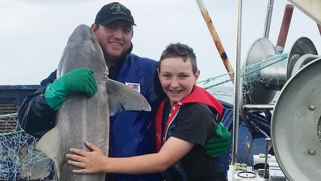 Warwick and Noah Treloggen on board the fishing vessel Japara, which caught fire about an hour after the picture was taken and sank close to Three Hummock Island.