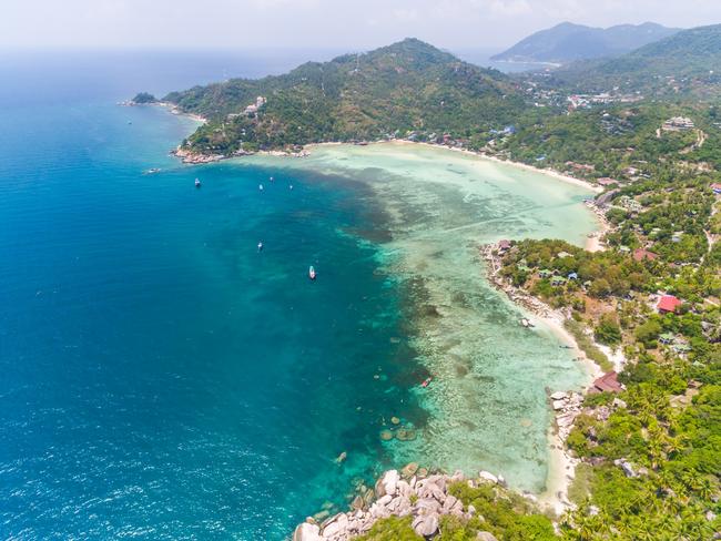 Aerial view of beach and boats surrounding Koh Tao Island, in Thailand.