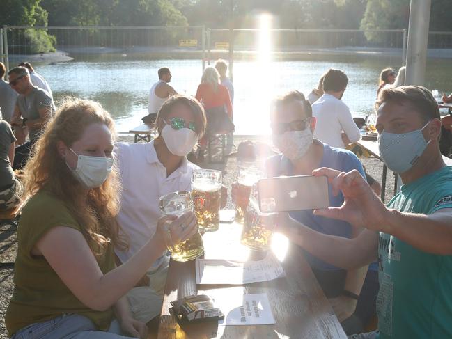 Guests enjoy the atmosphere of a beer garden in Munich. Picture: Getty