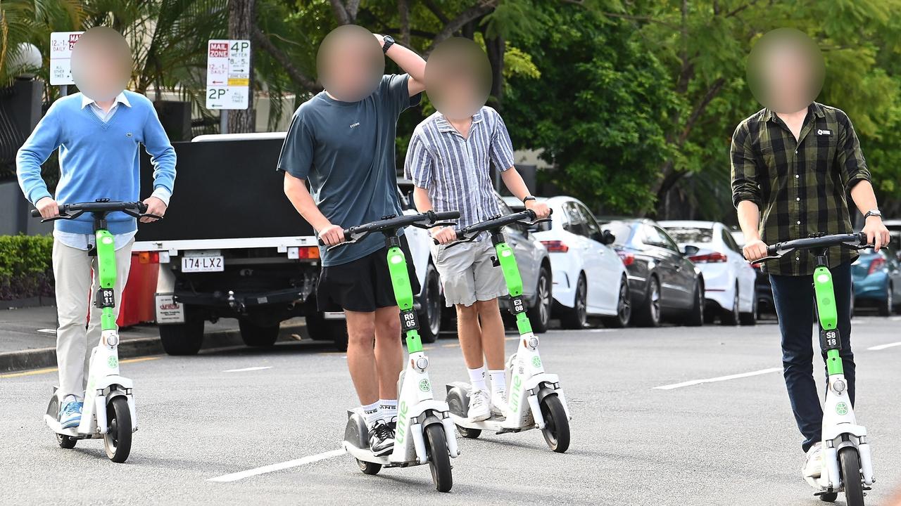 Young e-scooter riders in Brisbane not using helmets. Picture: John Gass