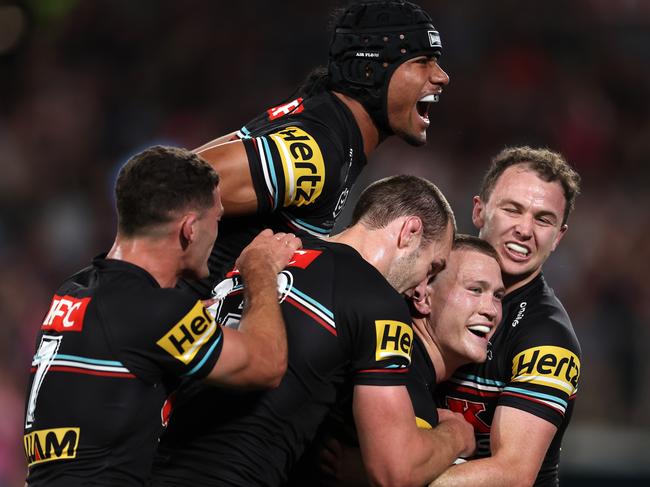 Windsor junior Mitch Kenny is mobbed by teammates after his try in the 2023 grand final, including St Clair junior Stephen Crichton (top) and Brothers product Nathan Cleary (left). Photo: Matt King/Getty Images