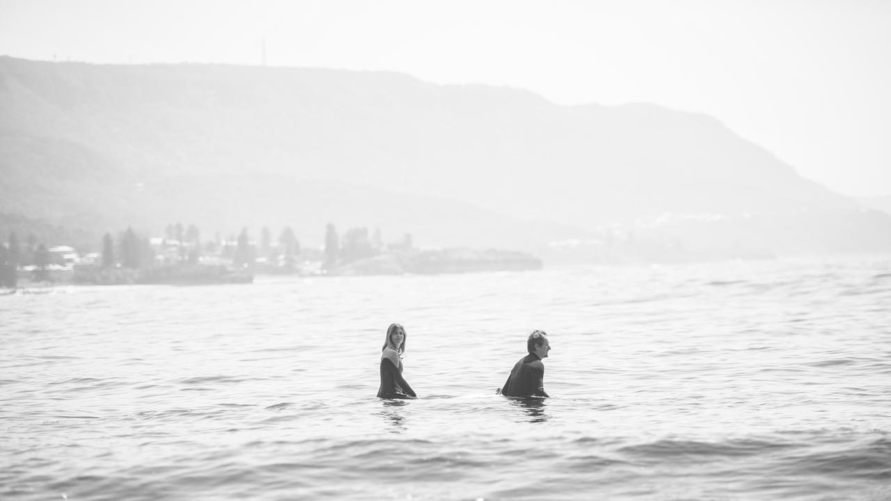 <i>Picture: The Australian’s Bridget Cormack paddles out with Tognetti.</i> <br/>“Everyone bangs on about the relationship in my life between surfing and music,” Tognetti says. “For me, it is about the posture. Of course the way the sea swells and ­recedes is like a musical phrase. But some people don’t feel it like that. They don’t feel the music in the sea. Or they don’t feel the sea in the music.” Picture: Nic Walker