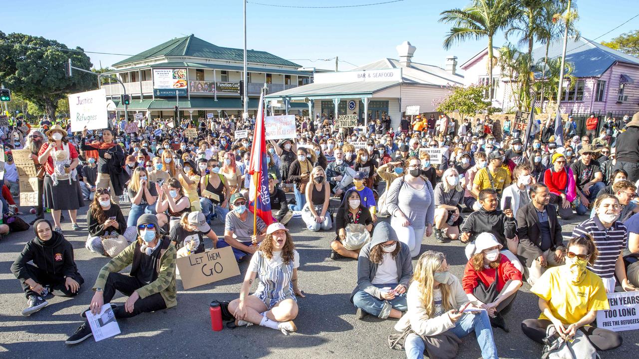 Protesters sit on Main St, blocking the road. Picture: Richard Walker