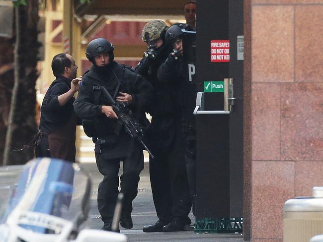 A hostage runs to safety outside the Lindt Cafe. Picture: Mark Metcalfe/Getty Images