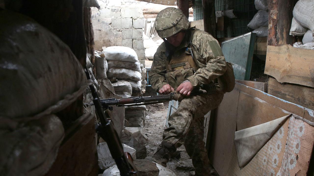 A Ukrainian serviceman cleans his machine gun at a position on the frontline with Russia-backed separatists near Gorlivka, Donetsk region, on April 15. Picture: STR/AFP