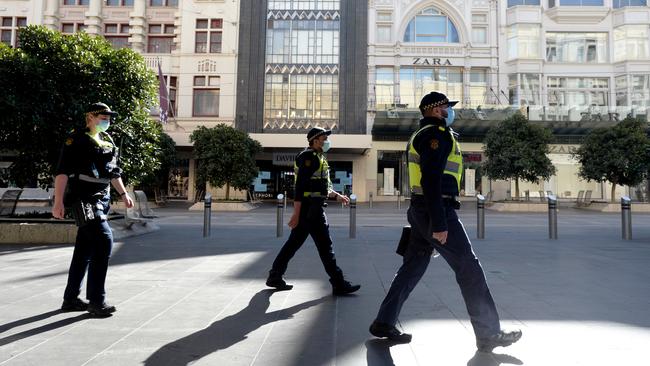 Police patrol an almost deserted Bourke Street Mall during stage four lockdown. Picture: Andrew Henshaw