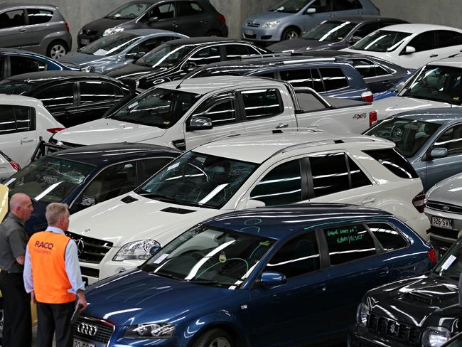 CMNEWS_RACQ Staff assess damages to vehicles this afternoon Monday Dec.1st, 2014. Thousands of motor vehicle will be inspected by dozens of insurance companies over the next week after violent hail storm hit Brisbane late Thursday afternoon causing millions of dollars in damage. Pictures: Jack Tran / The Courier Mail