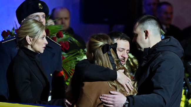 Volodymyr Zelensky and his wife Olena offer their condolences to the family of Denys Monastyrsky in Kyiv on Saturday. Picture: AFP